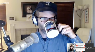 Tom wearing a NosillaCast had and drinking from a NosillaCast mug