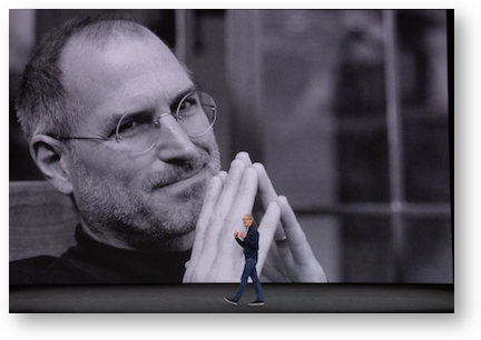 Tim walking in front of huge steve jobs