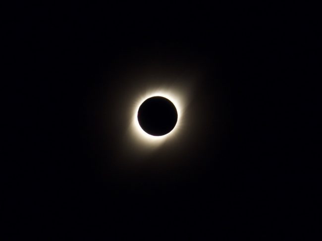 Total Eclipse showing white bands longer at the electromagnetic poles