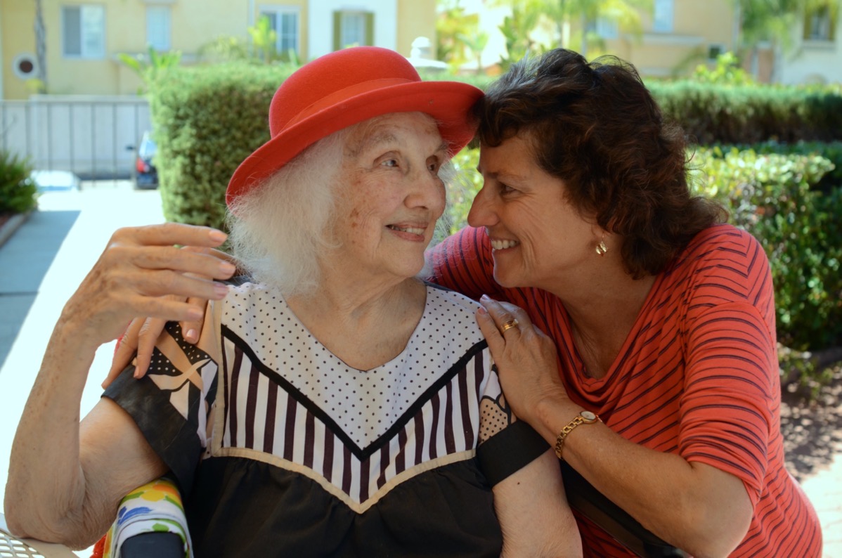 Jeanne looks at Allison red hat