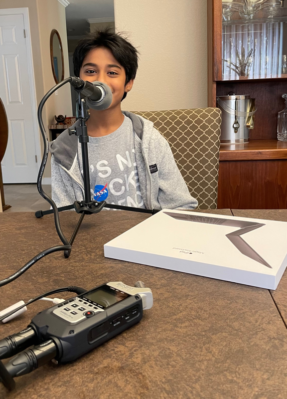 Armaan at the Mic wearing a NASA shirt that says it is not rocket science