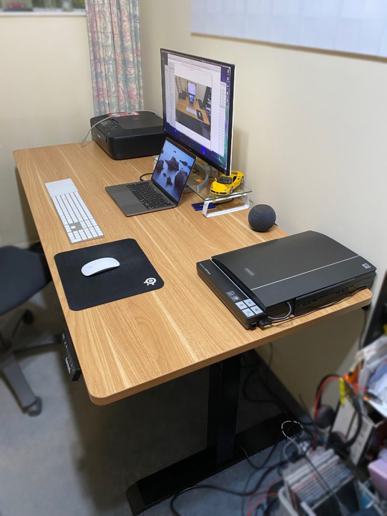Loctek Standing Desk with a scanner laptop, secondary monitor, printer, keyboard and mouse