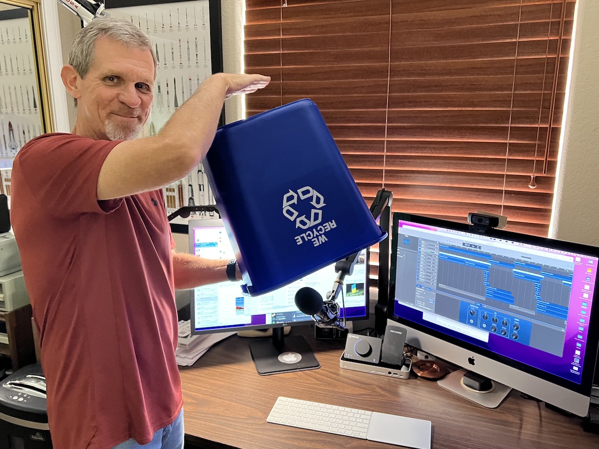 Steve holding upside down recycling bin over the mic