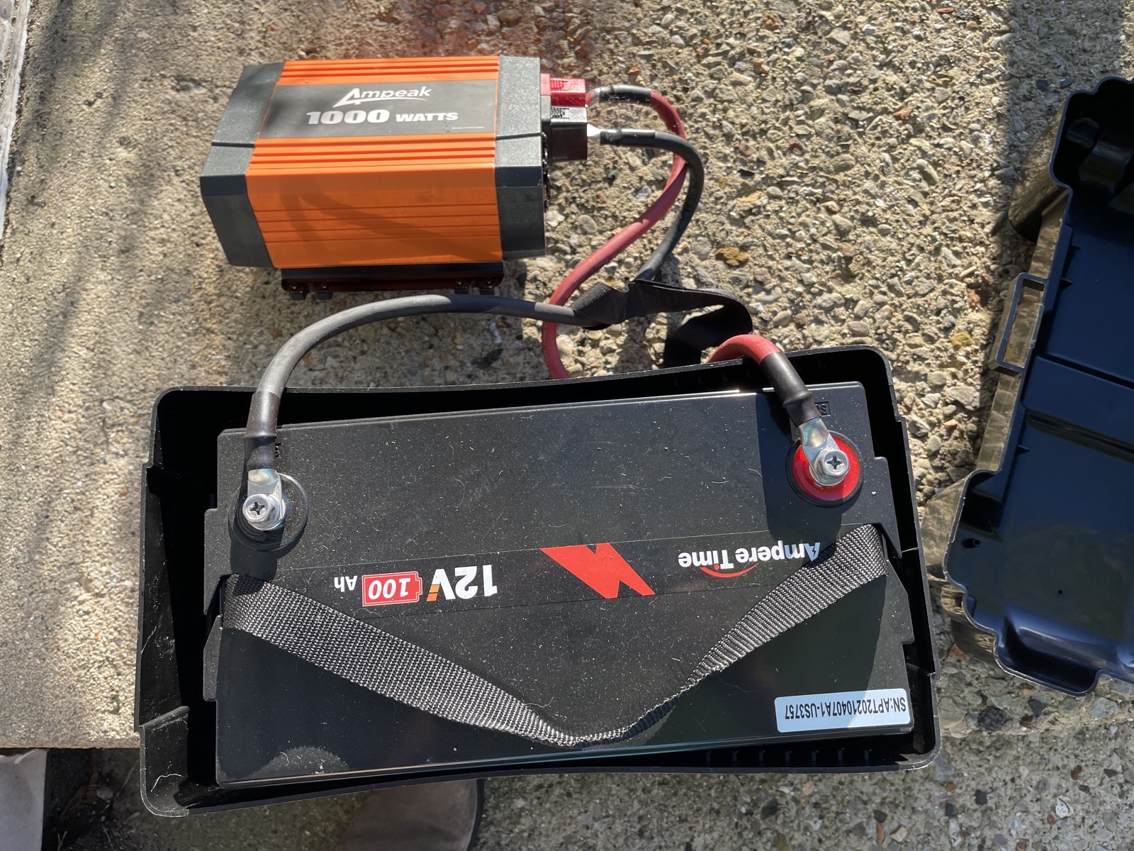 12V Battery with two leads going to the Ampeak 1000 Watt inverter box