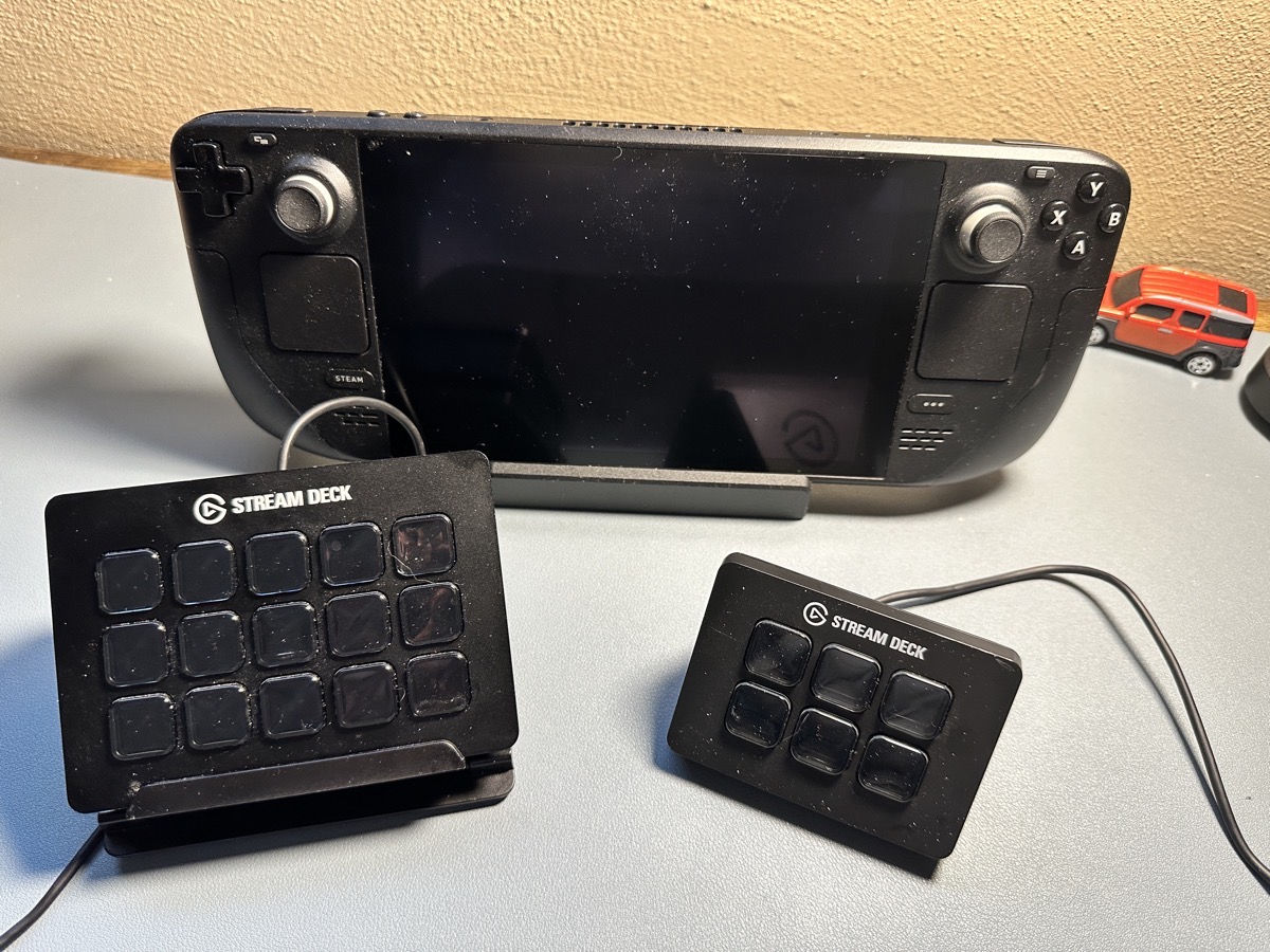 Steam Deck in the dock with two Elgato Stream Decks in front - not confusing when you can feel them with your hands, just hard to say!
