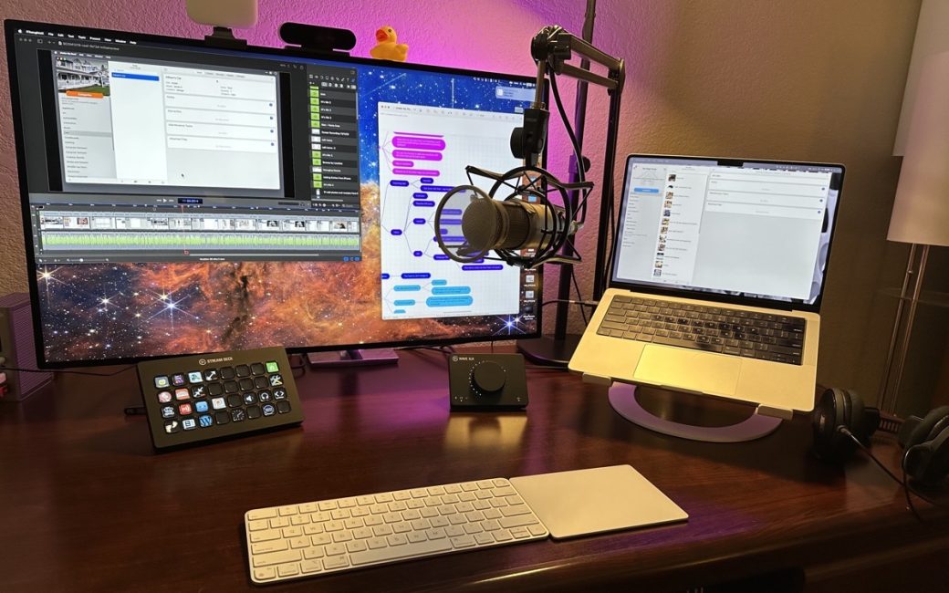 Big Display with MacBook on Stand to the Right and Mic Inbetween