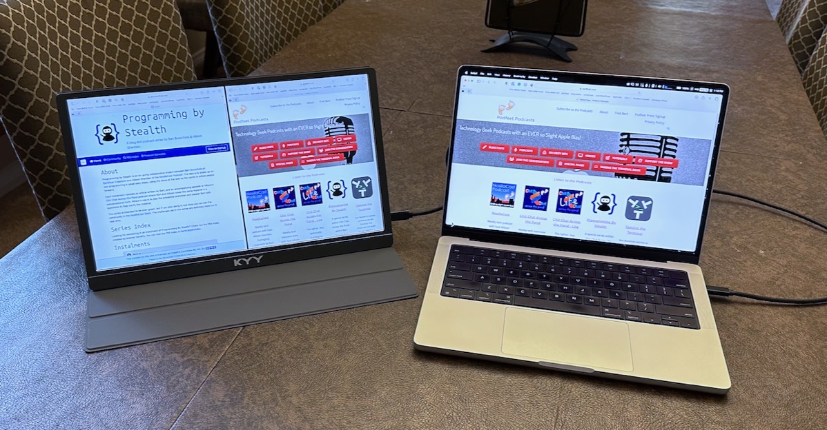 KYY Display to the Left of a 14 MacBook Pro - Mac has podfeet dot com showing while KYY has Podfeet side by side with pbs dot bartificer dot net showing Programming By Stealth shownotes