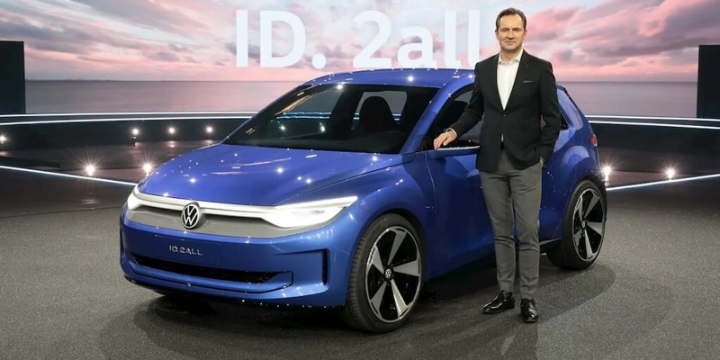 VW-ID.-2all.jpeg VW ID 2all blue tiny car with man standing next to it