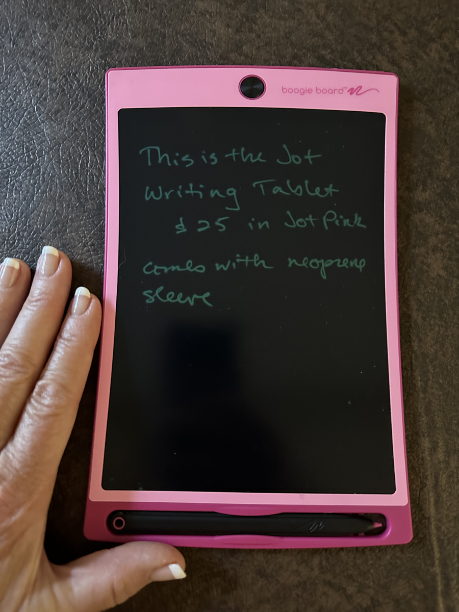 Boogie Board Jot Writing Tablet - pink border, about 2X the size of my hand, stylus clipped at the bottom, erase button at the top