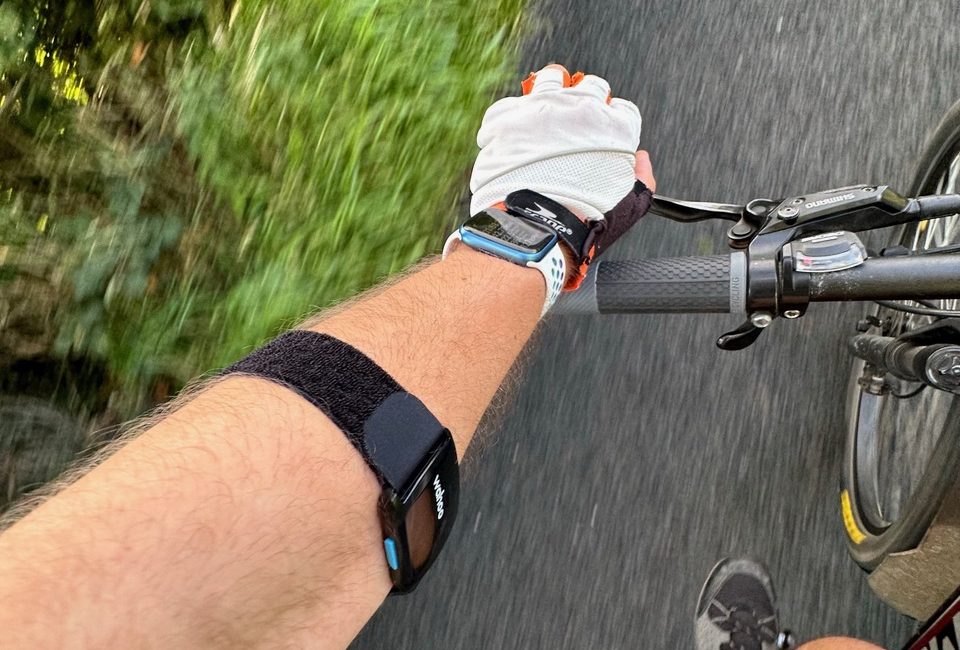 The Wahoo Trackr Fit on Bart's arm while cycling with his Apple Watch tracking the workout
