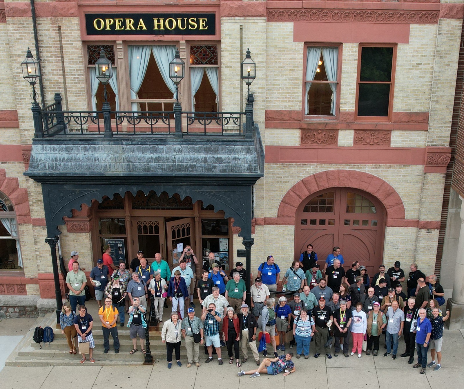 Group drone photo in front of the opera house and stage left