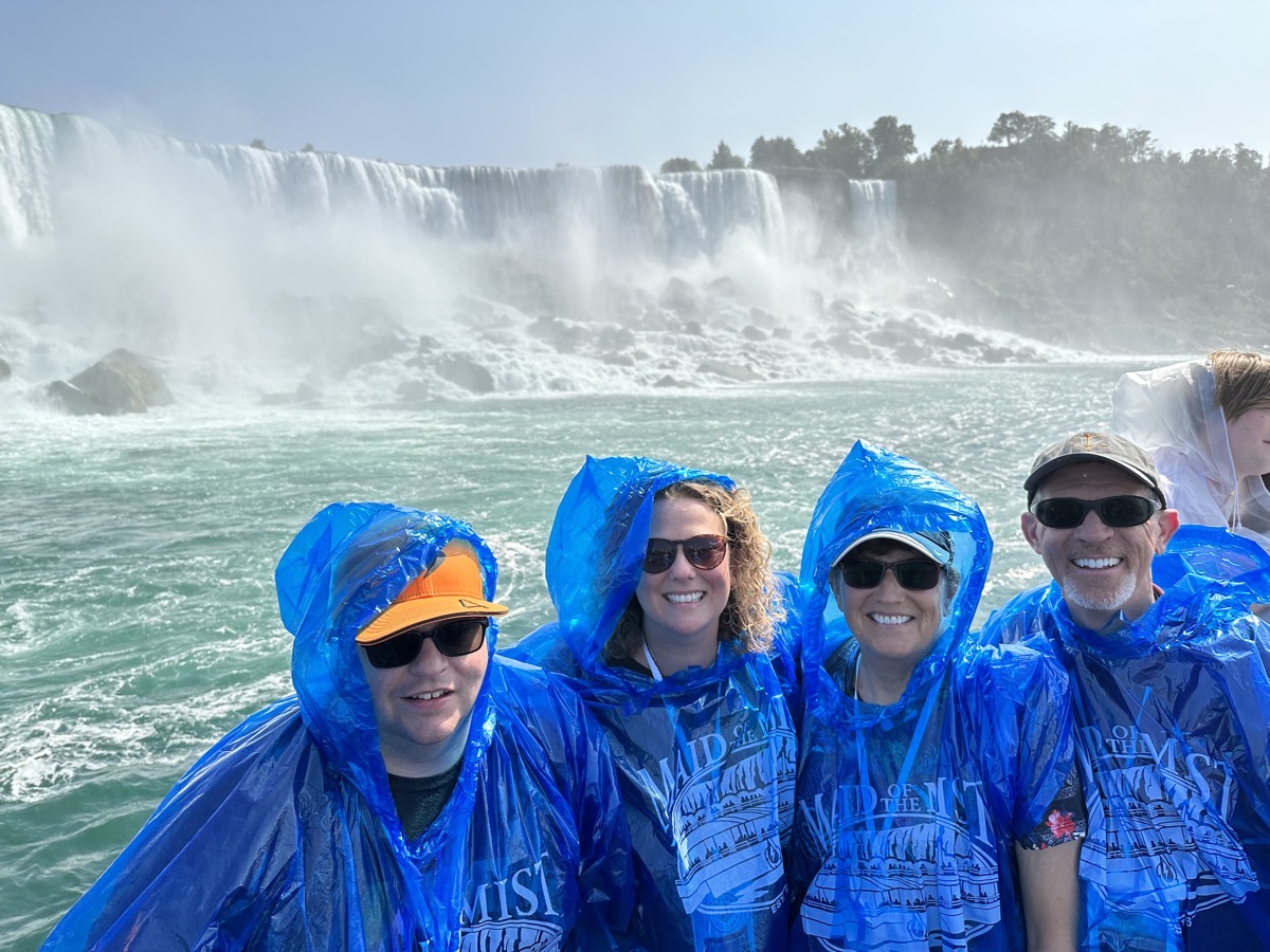Steven, Lindsay, Allison, Steve in blue panchos in front of Niagra Falls