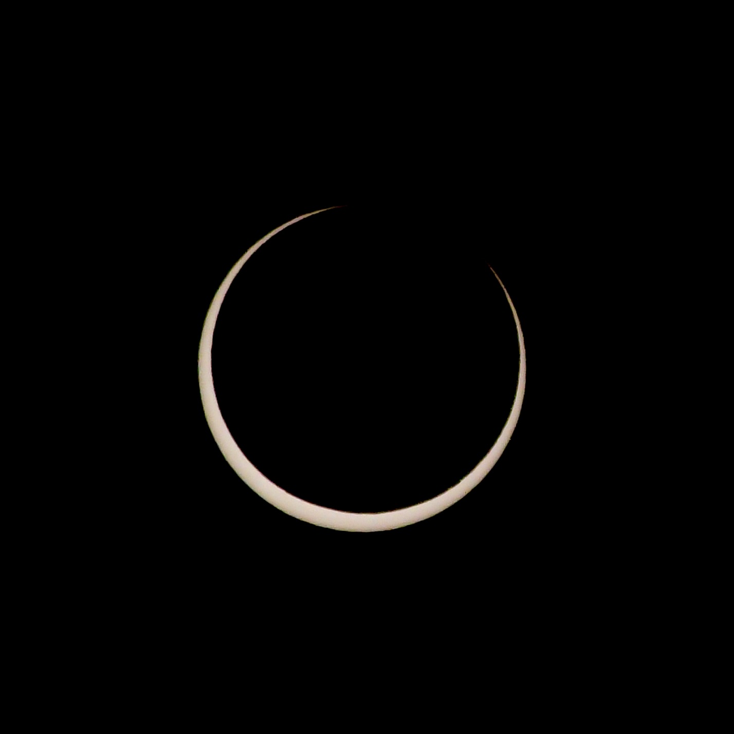 thin crescent sun as the moon is almost centered over it