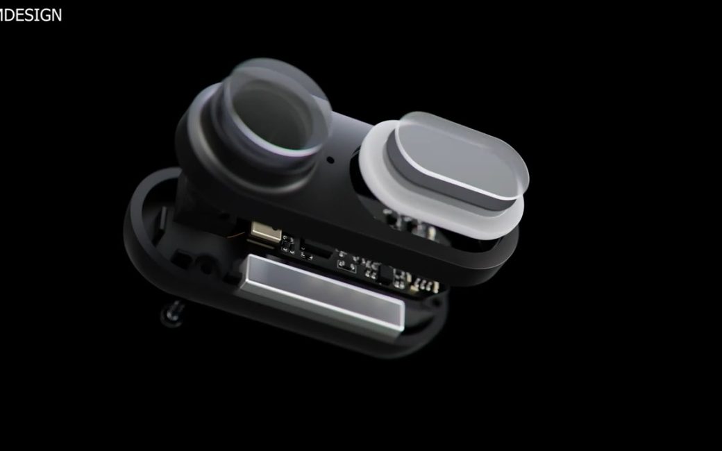 Exloded view of SLIMDESIGN compact body camera showing the front with a small lens and an oval button and the electronics behind the camera and lens.