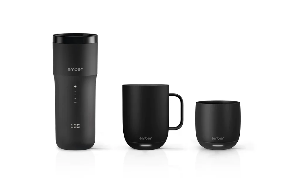 Front view of three Ember drinkware products: the Ember Traveler Mug with LED front panel and lid, the 14-oz Ember Mug with handle, and the 10-oz Ember Cup without a handle.