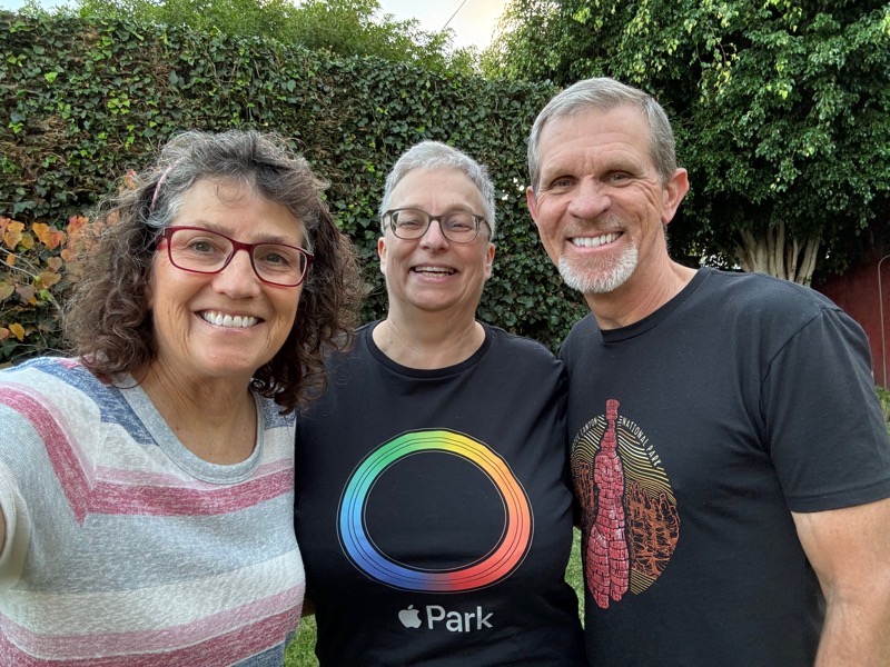 Allison Helma Steve outside smiling arm in arm. Helma is wearing an Apple Park t-shirt