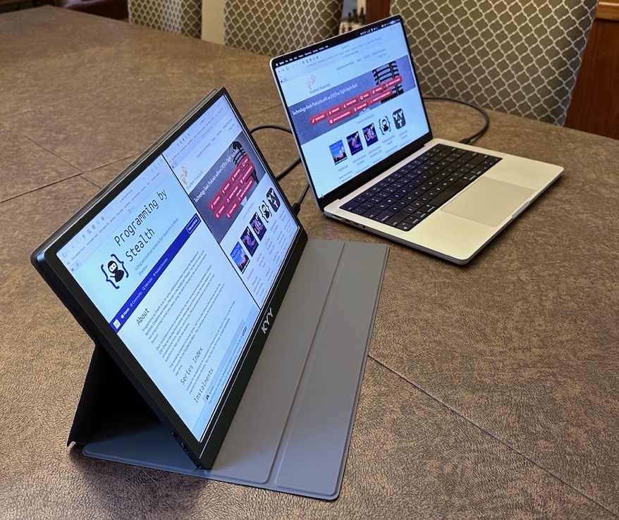KYY display beside MacBook Pro showing area case takes up on a table