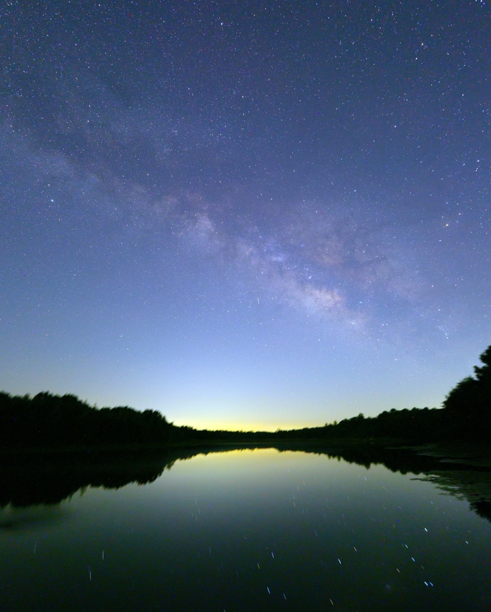 What you are seeing intros picture is the Milky Way both in the sky and reflecting on our pond. I took the picture right around the 4th of July so the northern hemisphere is “looking” as far south as possible allowing us to easily see the central section of the Milky Way