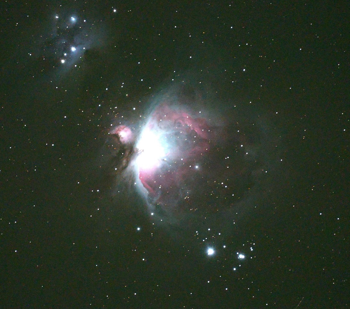 you can see the Orion Nebula with both reflected light and emission light from the glow of stars being born in the gas cloud which is the Orion Nebula. Reds, Blues, White, and even a hint of green is visible.