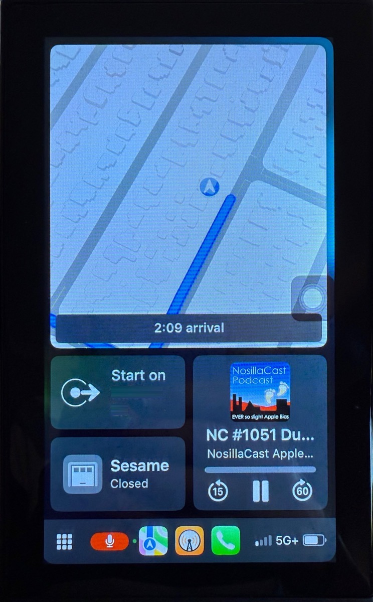 CarPlay screen showing maps on navigation podcast playing garage door button and dock below.