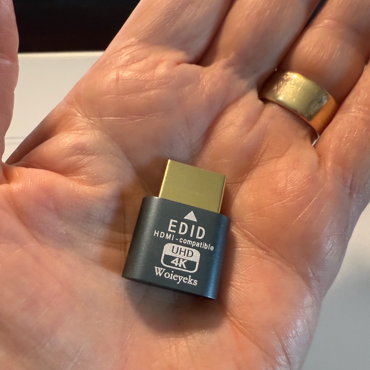 EDID HDMI dongle in the palm of a hand.jpeg EDID HDMI dongle in the palm of a hand.