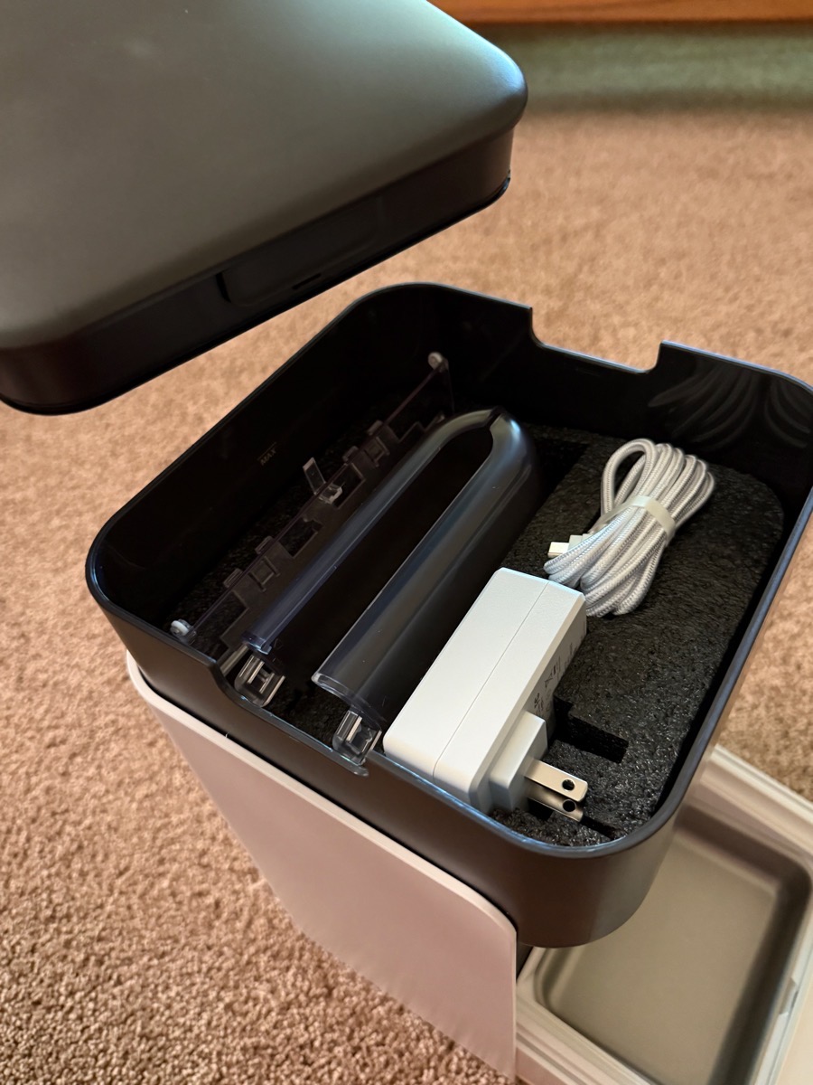 Top of food chamber open showing power supply and more parts.