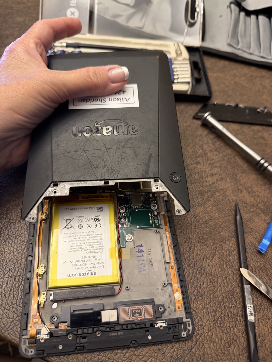 Kindle with cover off revealing battery.