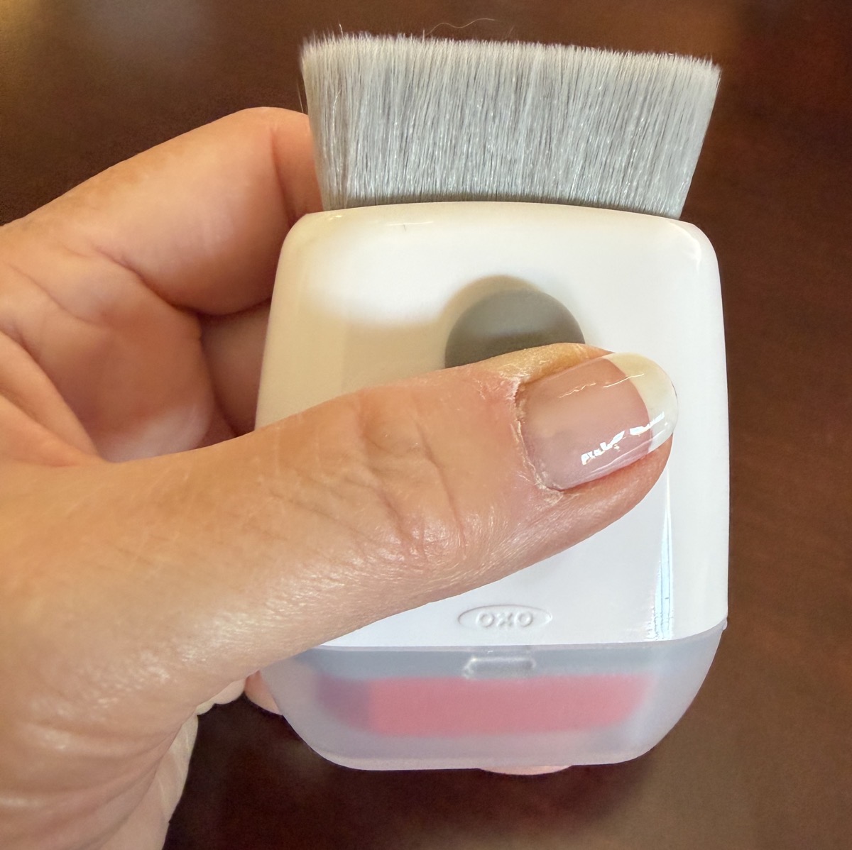 oxo sweep and swipe in the palm of a hand with the brush exposed and cloth swiper hidden.jpeg Oxo sweep and swipe in the palm of a hand with the brush exposed and cloth swiper hidden.