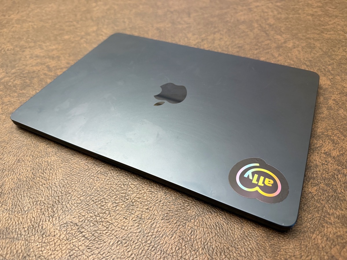 MacBook Air before showing fingerprints and smears and an a11y sticker.jpeg MacBook Air before showing fingerprints and smears and an a11y sticker.