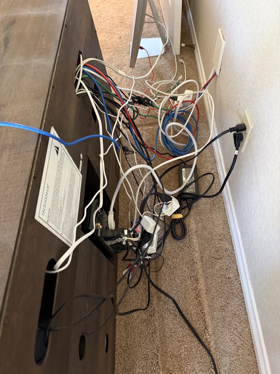 Lindsays room cables behind routers. So many cables. Ethernet and power in a big old mess.