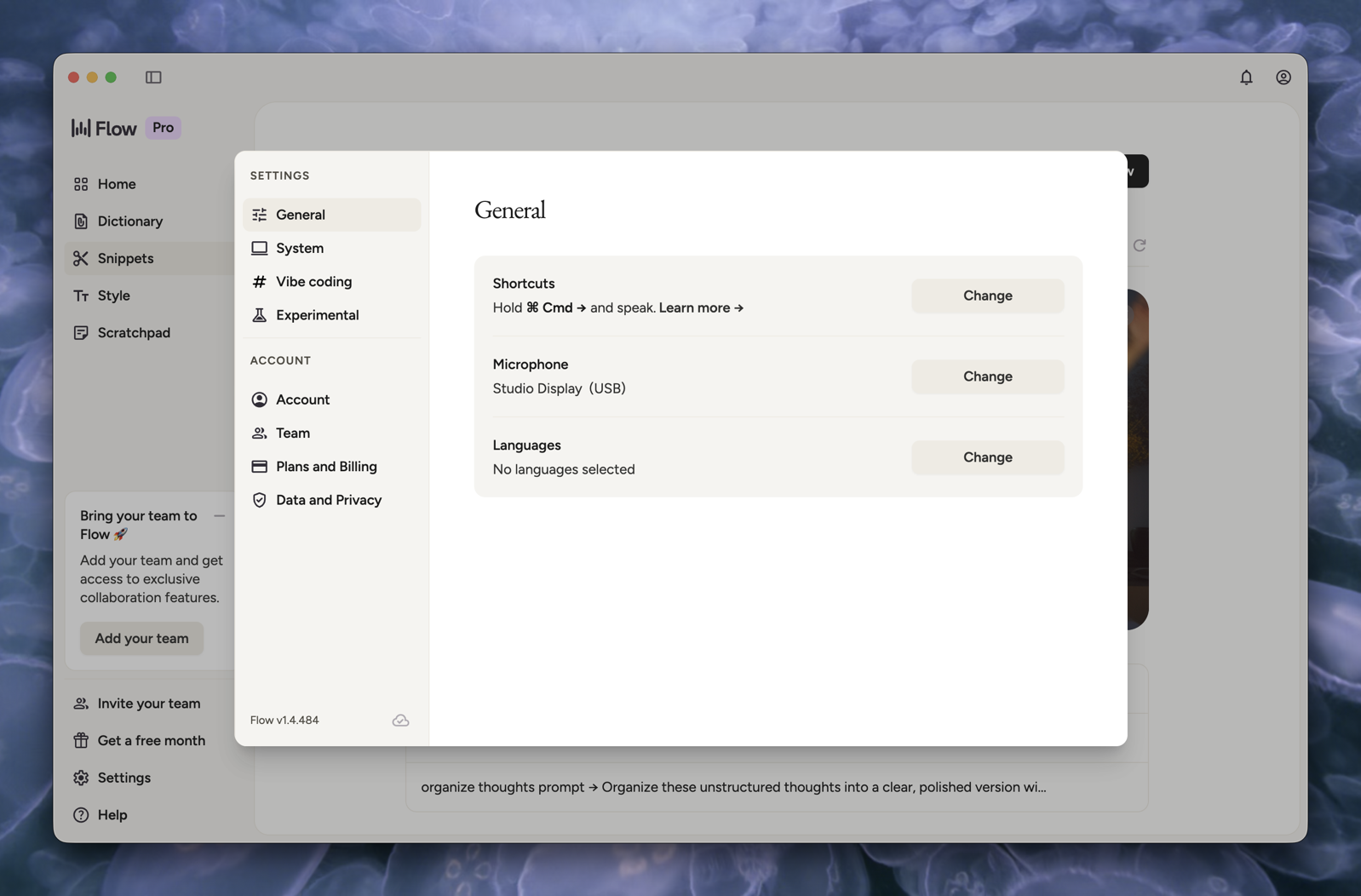 Wispr-Settings-General.png The Wispr Flow General Settings page on macOS, displaying three configurable options: Shortcuts set to "Hold Cmd right-arrow and speak" with a "Learn more" link and a Change button, Microphone set to "Studio Display (USB)" with a Change button, and Languages showing "No languages selected" with a Change button. The left sidebar lists settings categories including General, System, Vibe coding, and Experimental under Settings, and Account, Team, Plans and Billing, and Data and Privacy under Account. The app version "Flow v1.4.484" is shown at the bottom left.