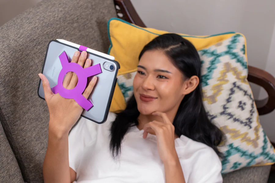 Strapsicle case on iPad mini held by woman lying down