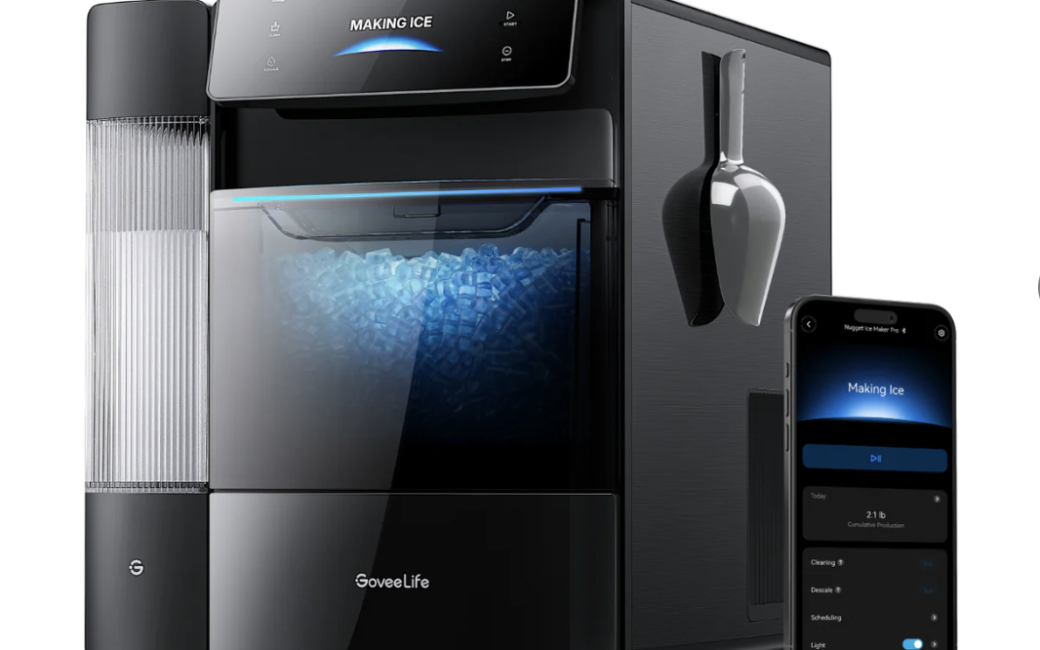 Promotional image of a black GoveeLife smart nugget ice maker with a glossy front panel and illuminated ice storage bin filled with small nugget ice. A digital display at the top reads “Making Ice,” while a matching smartphone app interface is shown beside the unit, displaying remote controls and production information. An ice scoop is mounted on the side, and a transparent water reservoir is visible along the left edge of the appliance.