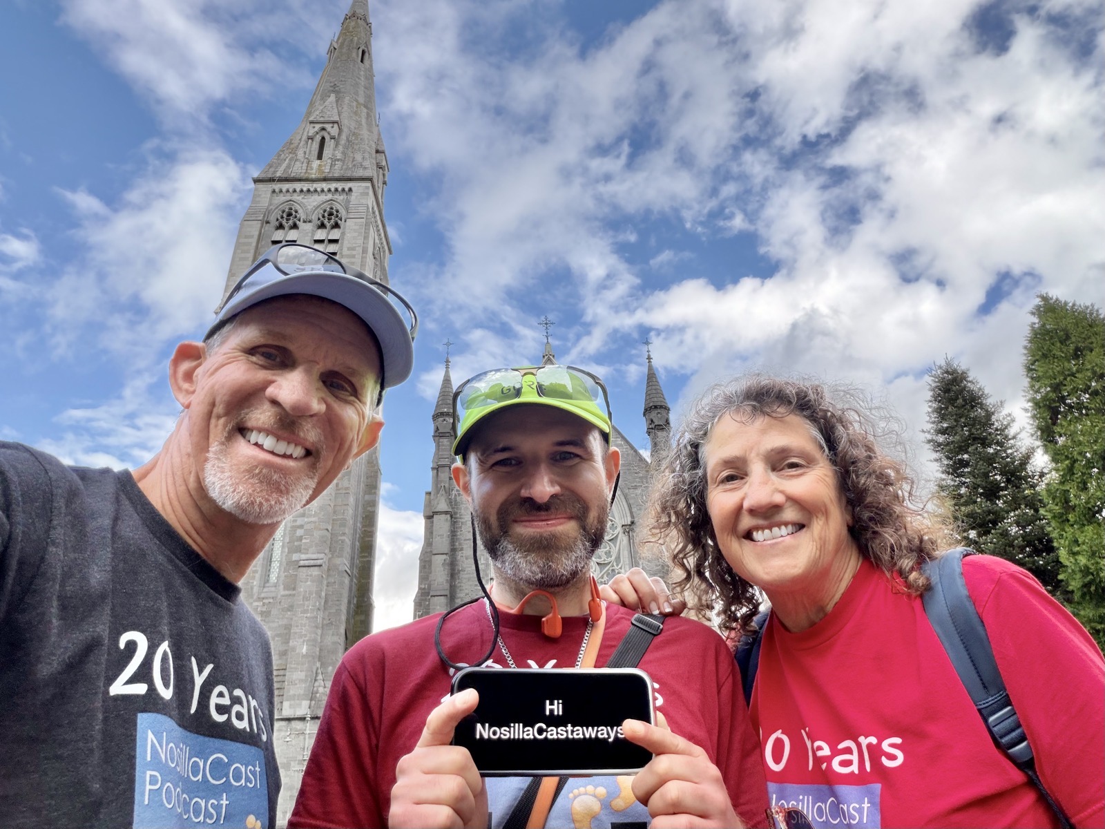 IMG_2623.jpeg Steve, Bart and me wearing our 20 year NosillaCast shirts standing in front of the spire at St. Patricks college and Bart is holding a phone that says Hi NosillaCastaways on it
