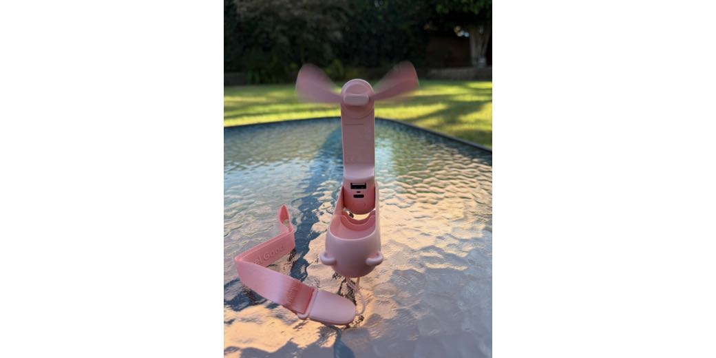 JisuLife personal turbo fan standing on a table with blades spinning